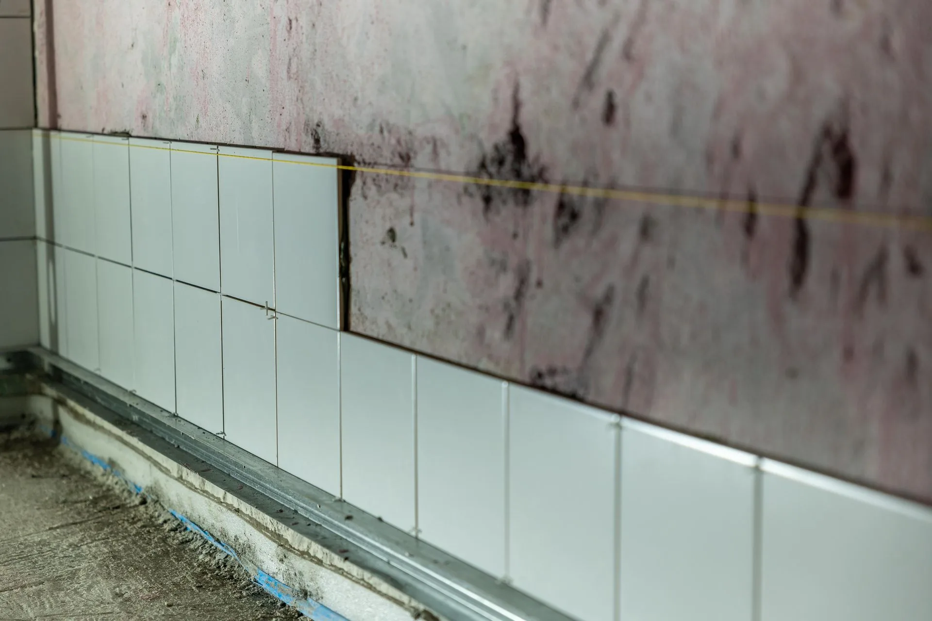 Wall tiling in progress on a renovation job